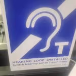 Sign indicating a hearing loop system is installed.